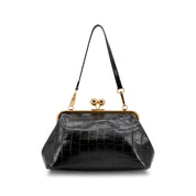 A black crocodile-embossed leather handbag with a gold-tone kiss-lock frame and shoulder strap, shown against a plain white background.