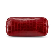 A Wine crocodile-embossed leather cosmetic pouch with rounded corners, shown on a clean white background.