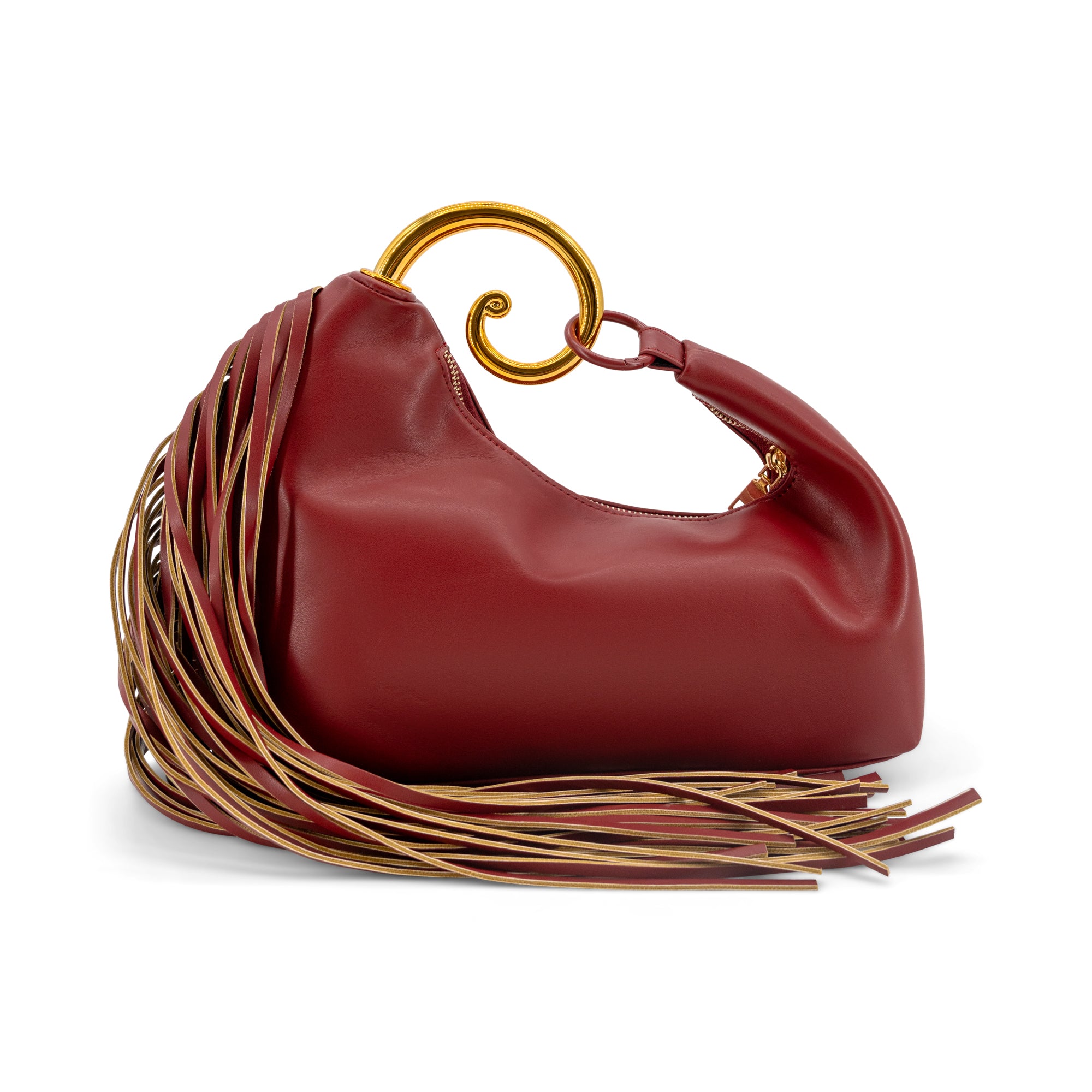 A red leather slouchy shoulder bag with a gold spiral handle and a long fringe detail in red and gold, shown on a white background.