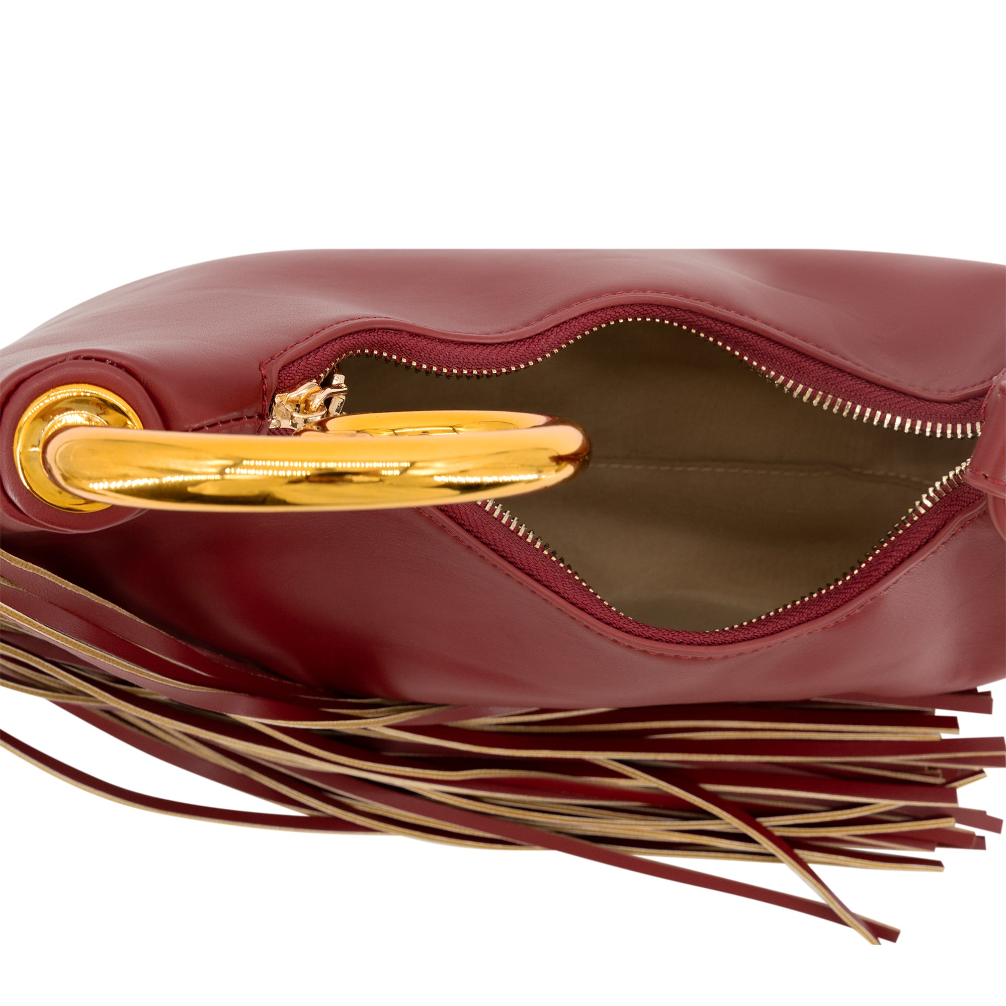 Close-up of a burgundy leather handbag with a gold-tone metal handle and a long fringe detail, shown open against a white background.