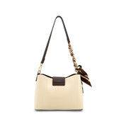 An Ivory textured shoulder bag with dark brown leather trim, a gold chain detail, and a matching brown and gold patterned scarf charm, shown on a plain white background.