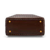 The bottom corner view of a dark brown snakeskin leather handbag, showing the textured pattern, a smooth brown leather trim, and four gold-tone metal studs on a white background.