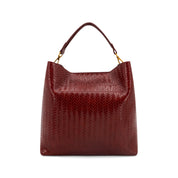 A Wine  textured leather handbag with a top handle and gold-tone hardware, shown against a plain white background.