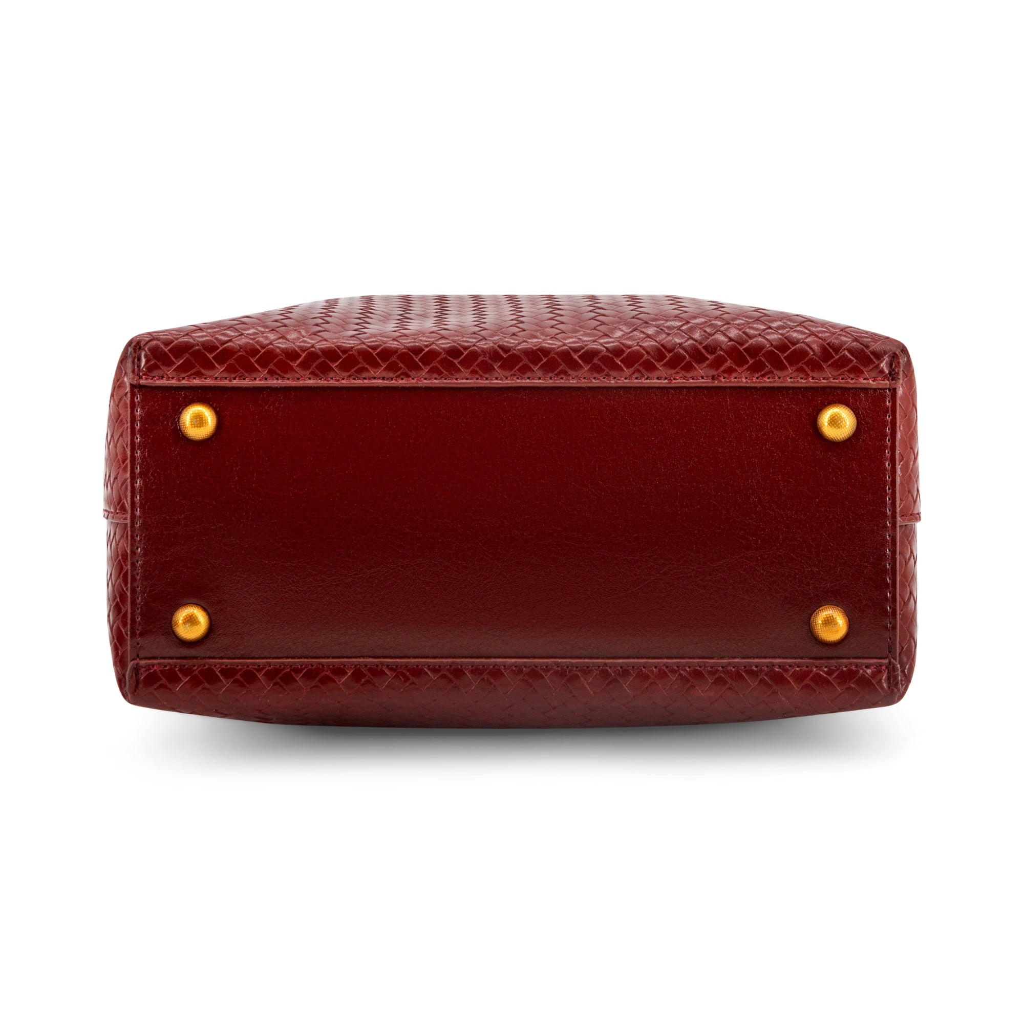 The bottom corner of a Wine  crocodile-embossed leather handbag, showing gold-tone metal studs on a white background.