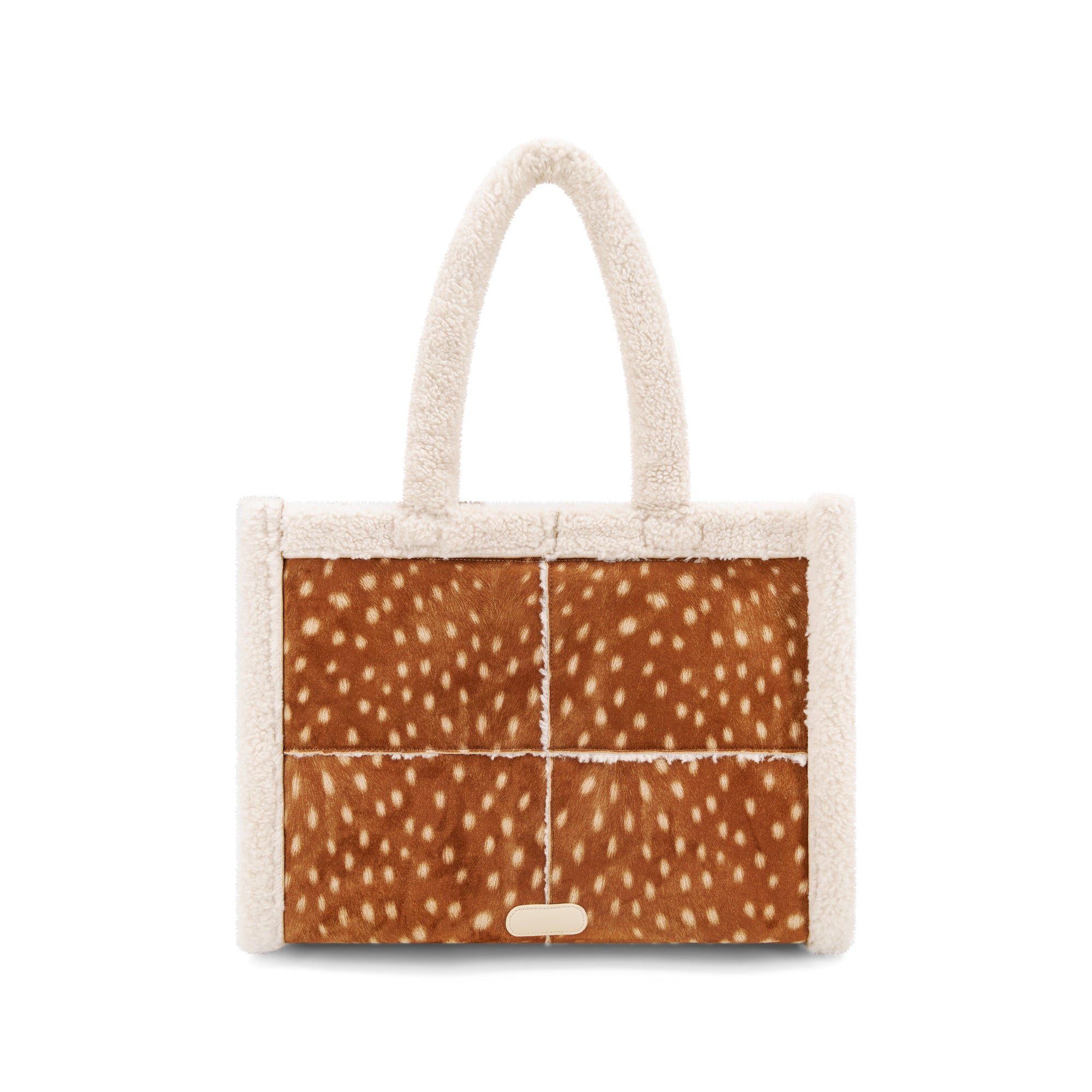 A small structured tote bag with cream-colored plush faux fur trim and handles, featuring a front panel made of four brown animal-print panels with white spots, resembling deer or cowhide.
