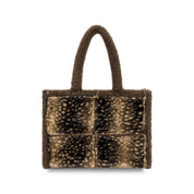 A small structured tote bag with a textured, fuzzy exterior featuring a brown and beige spotted animal-print pattern, with solid brown handles, shown against a plain white background.