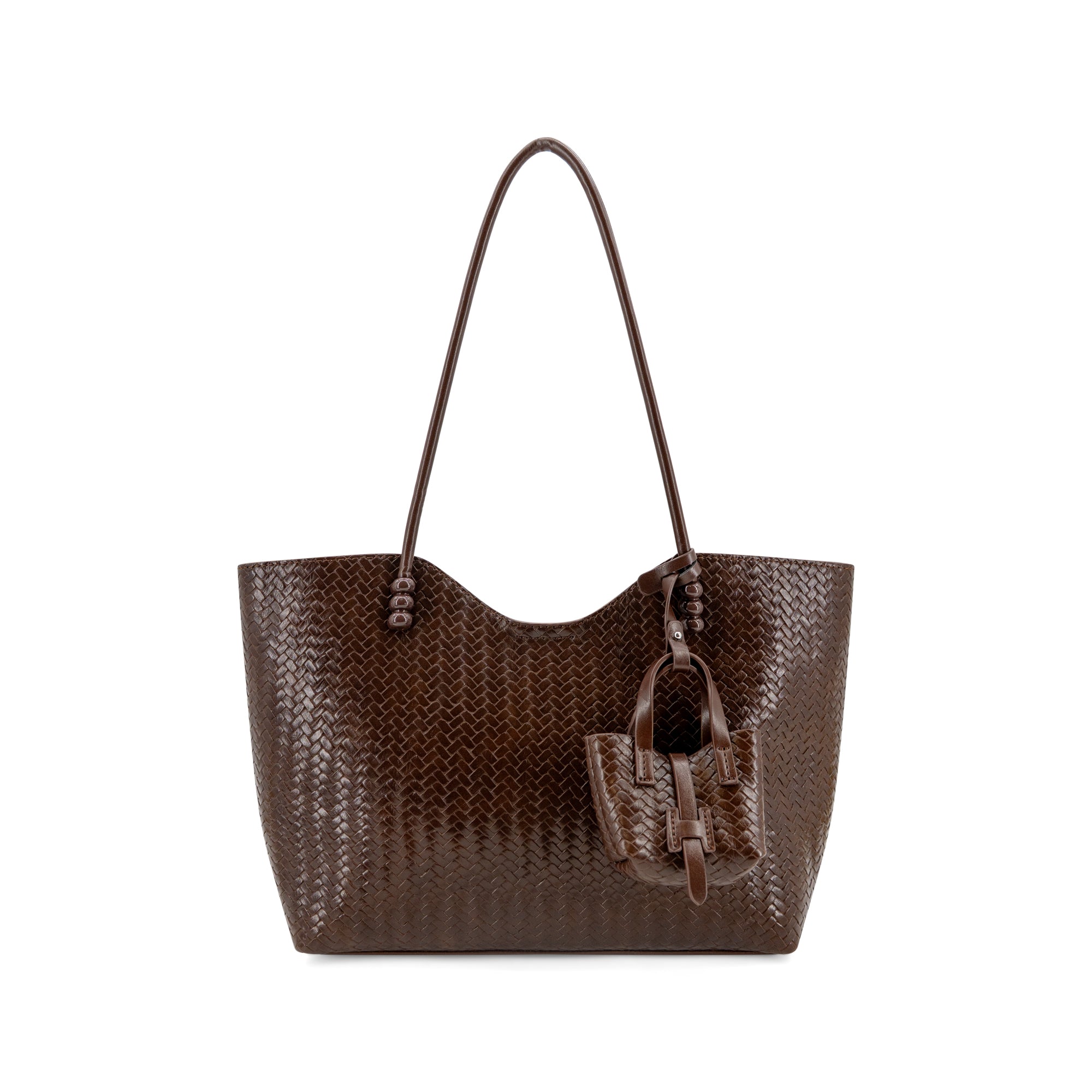 A dark brown woven leather tote bag with a matching leather hanging charm, displayed against a solid white background.