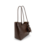 A dark brown woven leather tote bag with long shoulder straps and a hanging leather tag, shown on a clean white background.