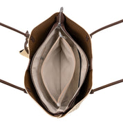 Open view of a brown leather tote bag showing its beige interior lining, zippered compartments, and dark brown shoulder straps against a white background.