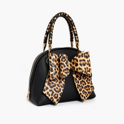 Black leopard-print bow crossbody bag with braided top handle, side view